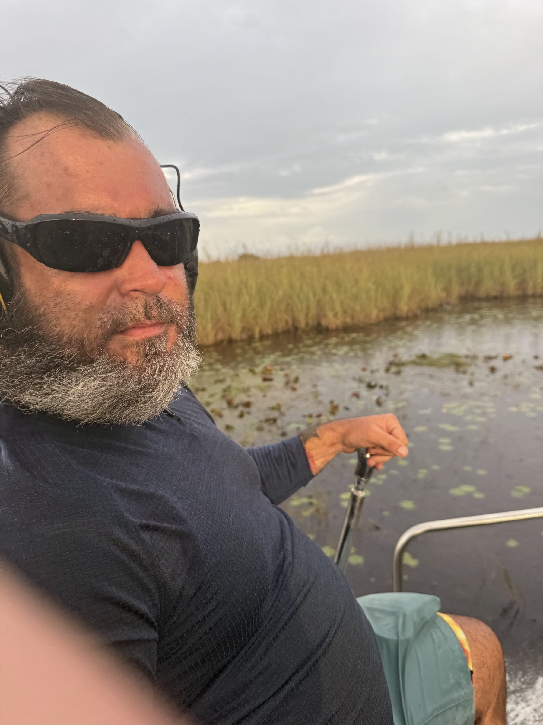 Experienced USCG-style airboat captain guiding a golden-hour Everglades airboat tour