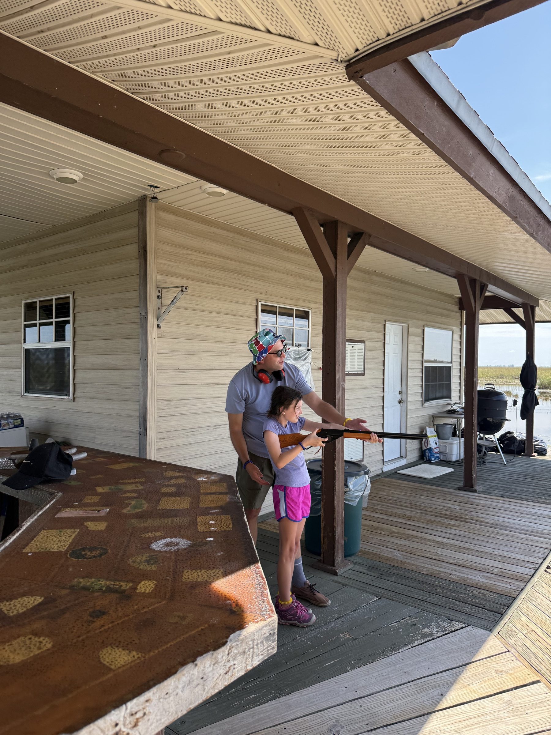 Guest learning to cast a fishing rod at the Aces Airboat Tours Everglades camp