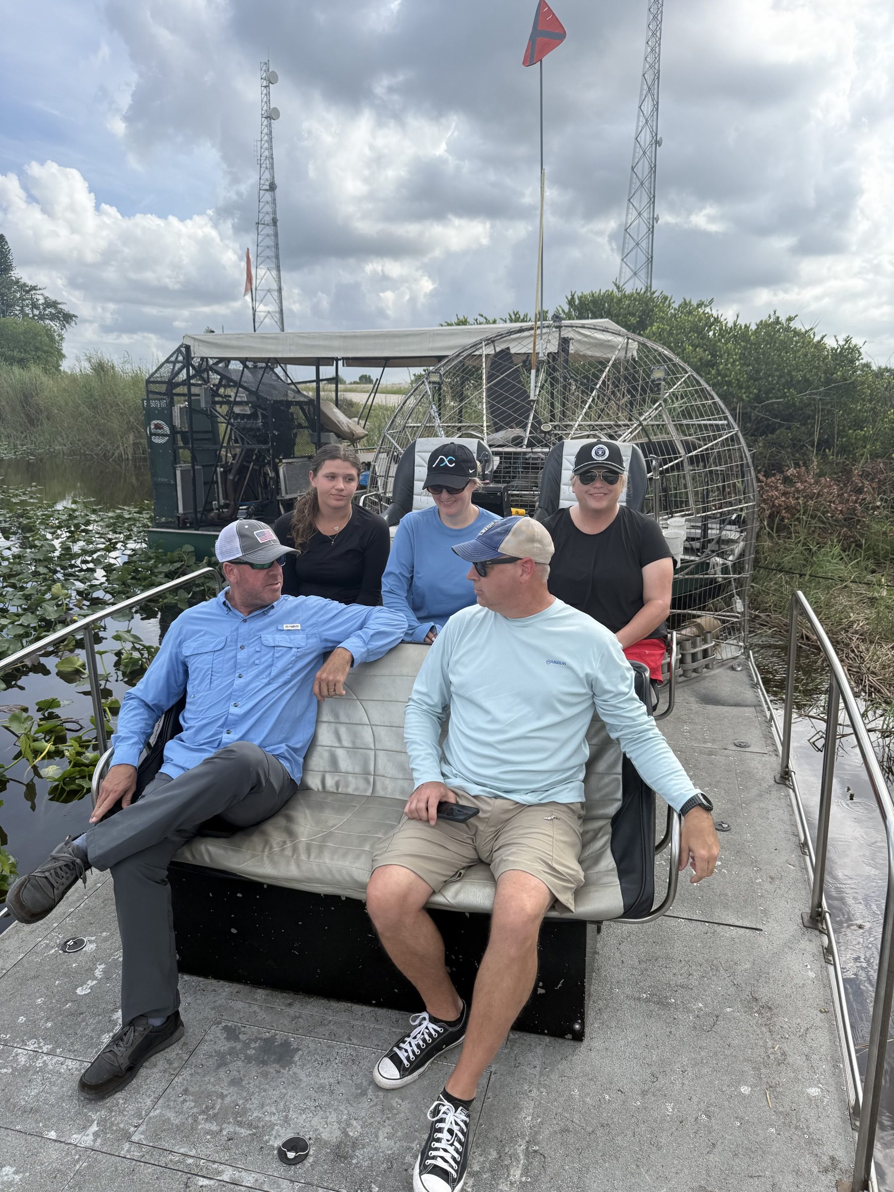 Five adults relaxing on an Aces Airboat Tours private Everglades airboat charter