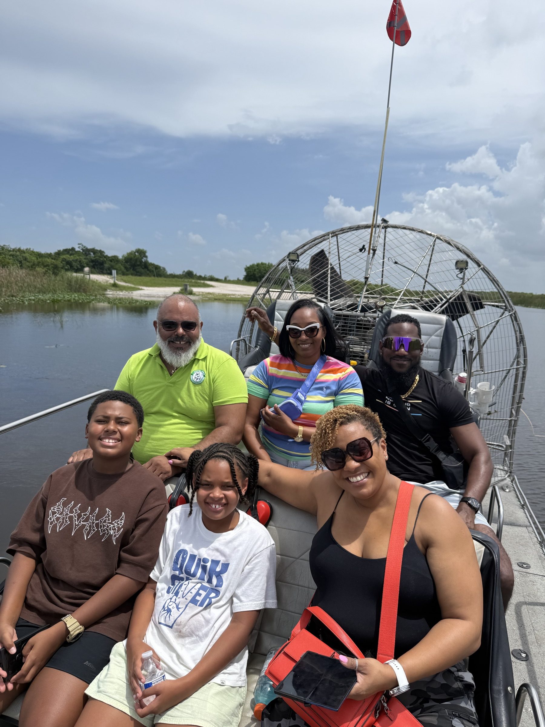 Multi-generation family smiling on one of our airboat tours Tamarac grandparents love