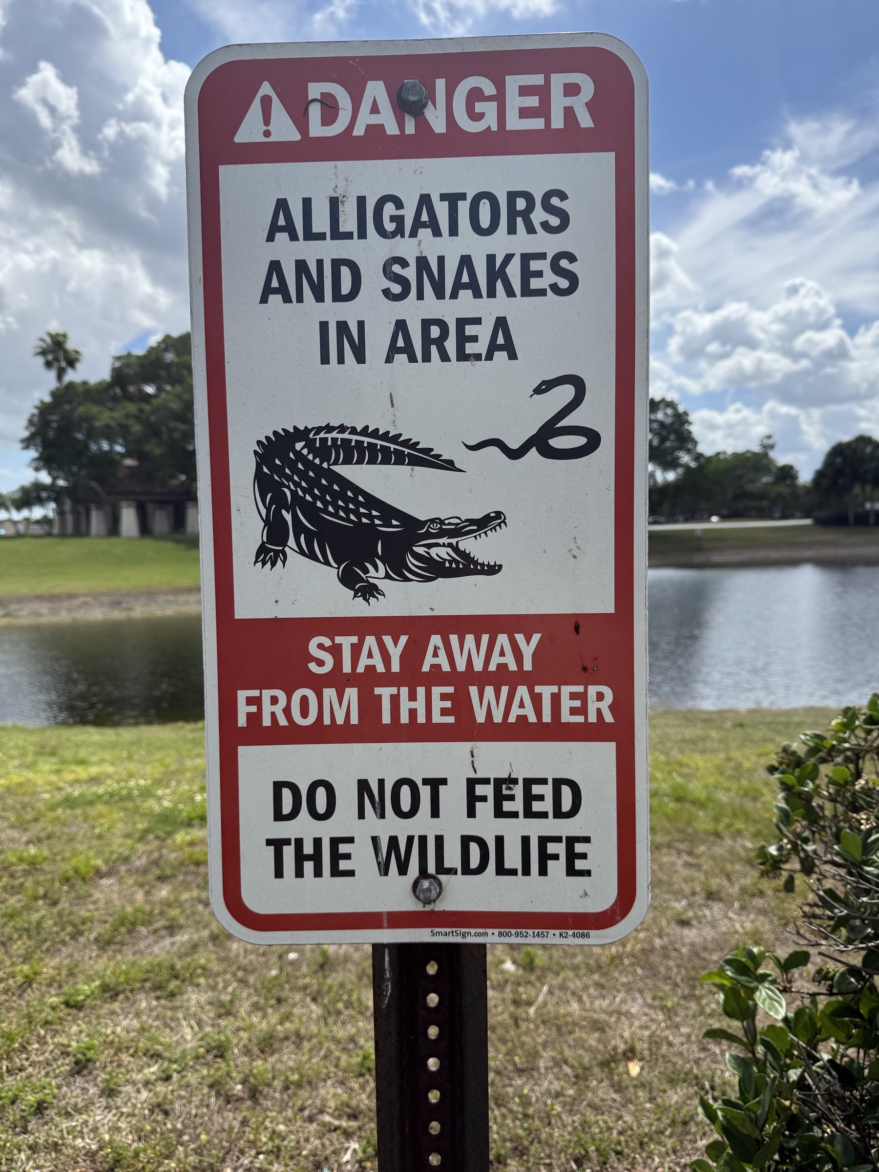 Alligators and snakes warning sign near the Everglades airboat launch used for alligator tours