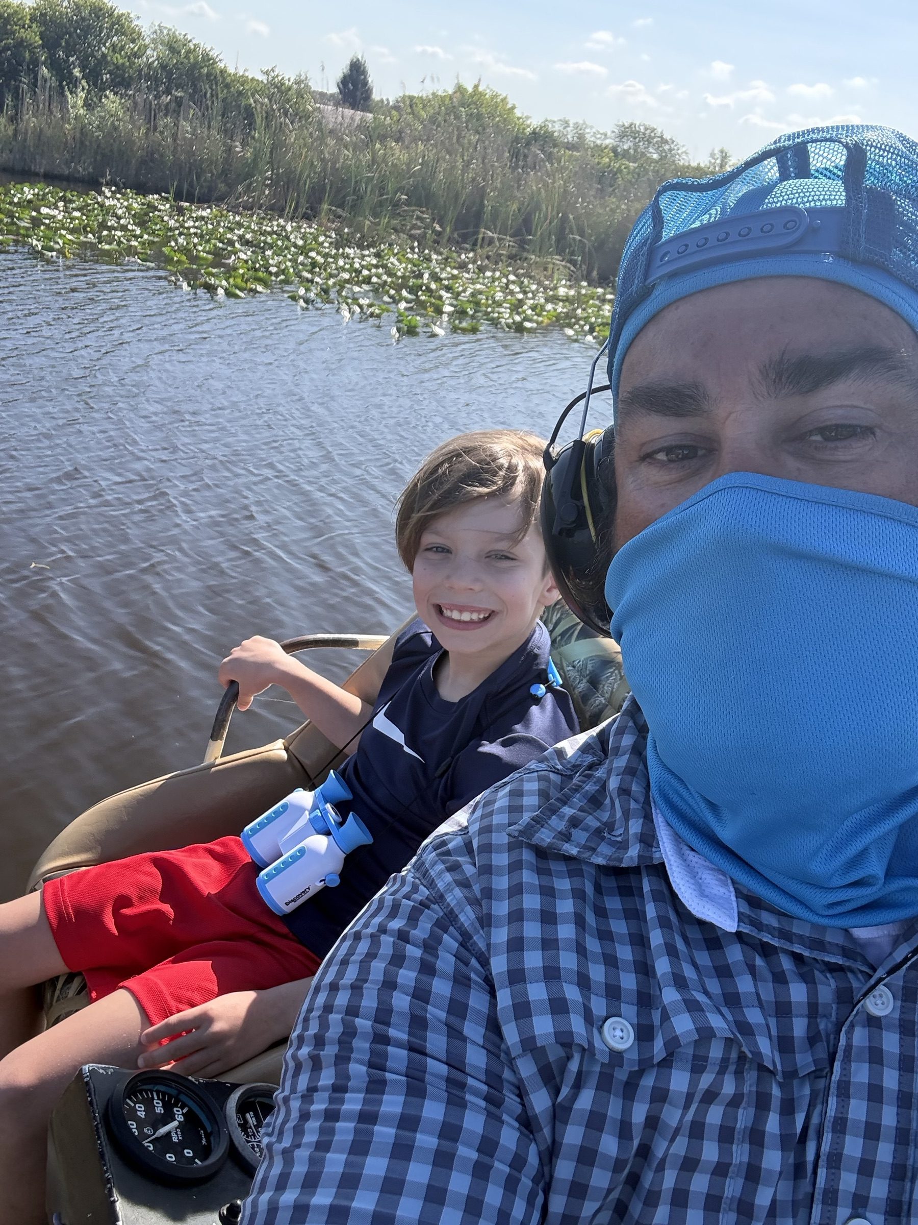 Aces Airboat Tours captain and a smiling boy on a family Everglades airboat tour