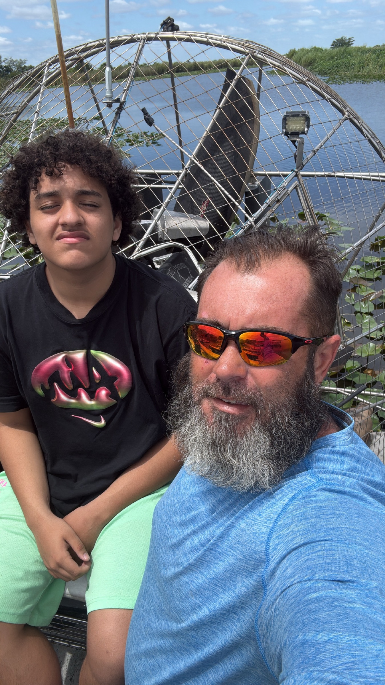 Captain and teen on one of the private airboat tours Jupiter families plan as a day trip