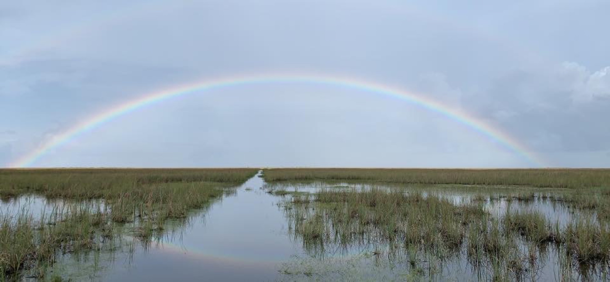 A rainbow arching over an Everglades water trail after the rain