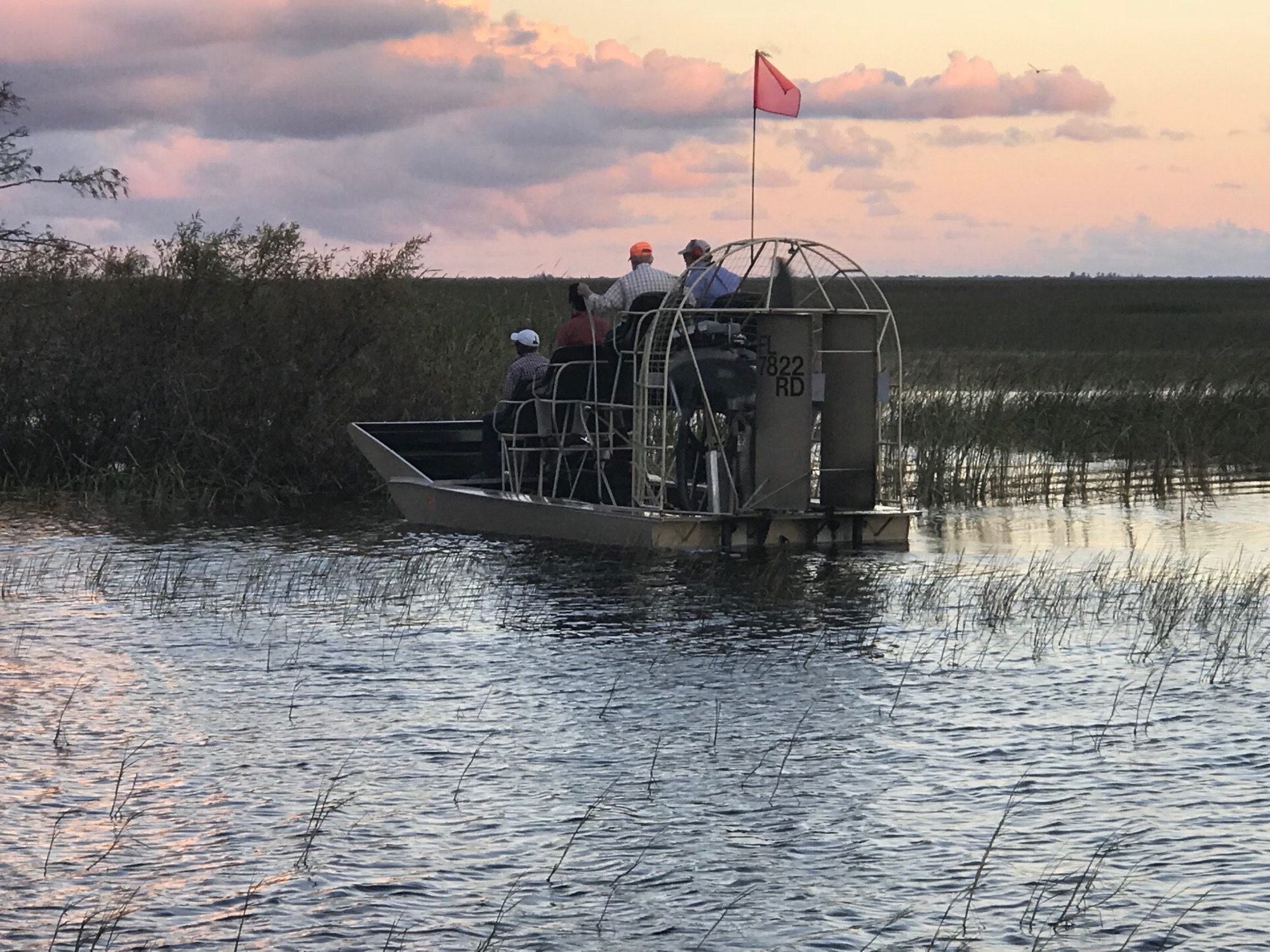 Guests aboard an Aces airboat at dusk in the Everglades