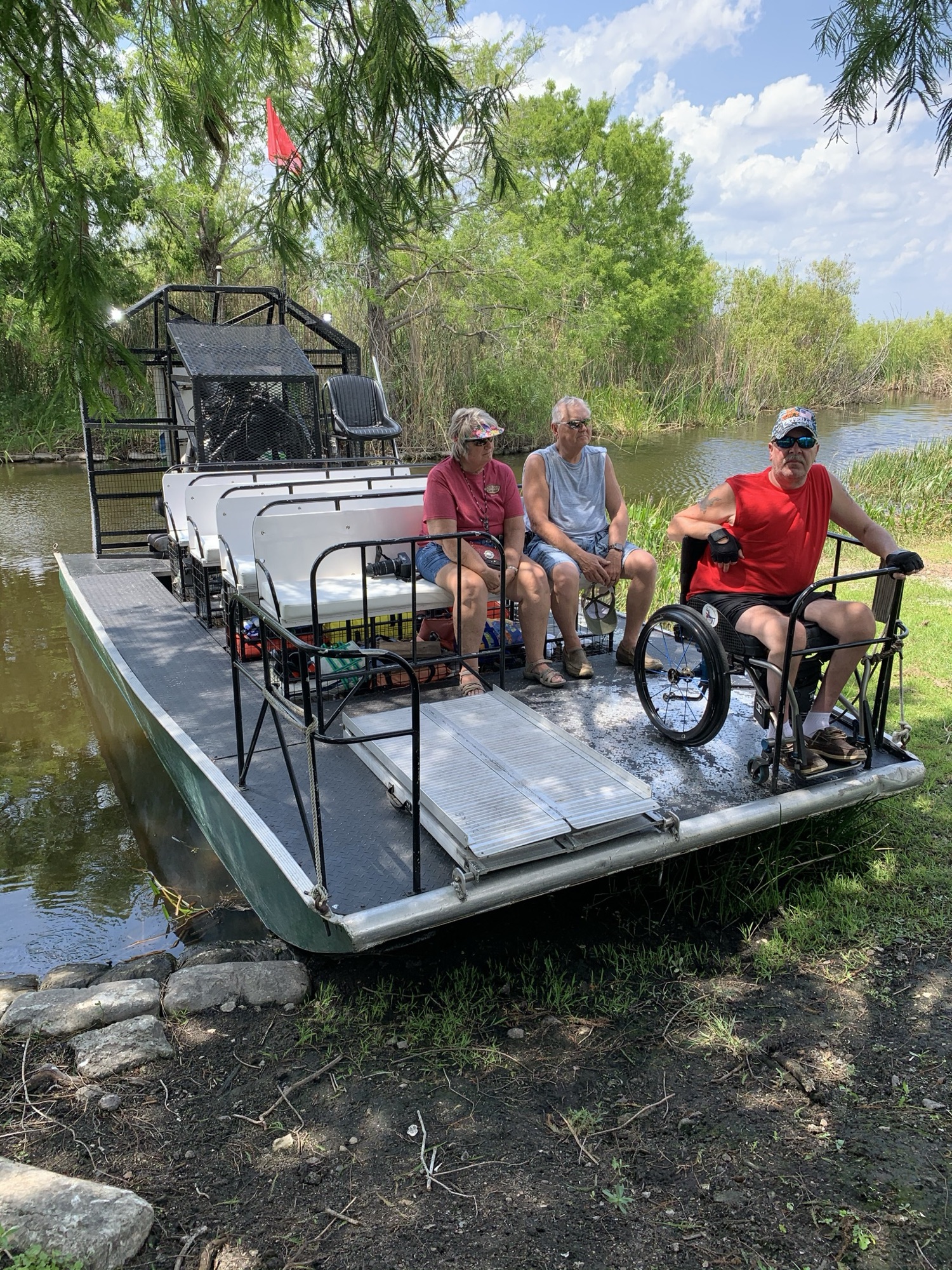 A guest using a wheelchair enjoying an accessible Everglades airboat tour