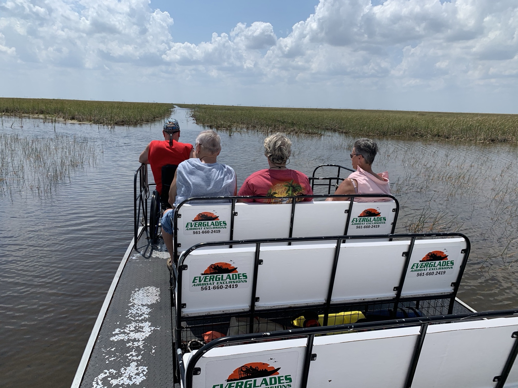 Guests smiling aboard an Aces Everglades airboat tour