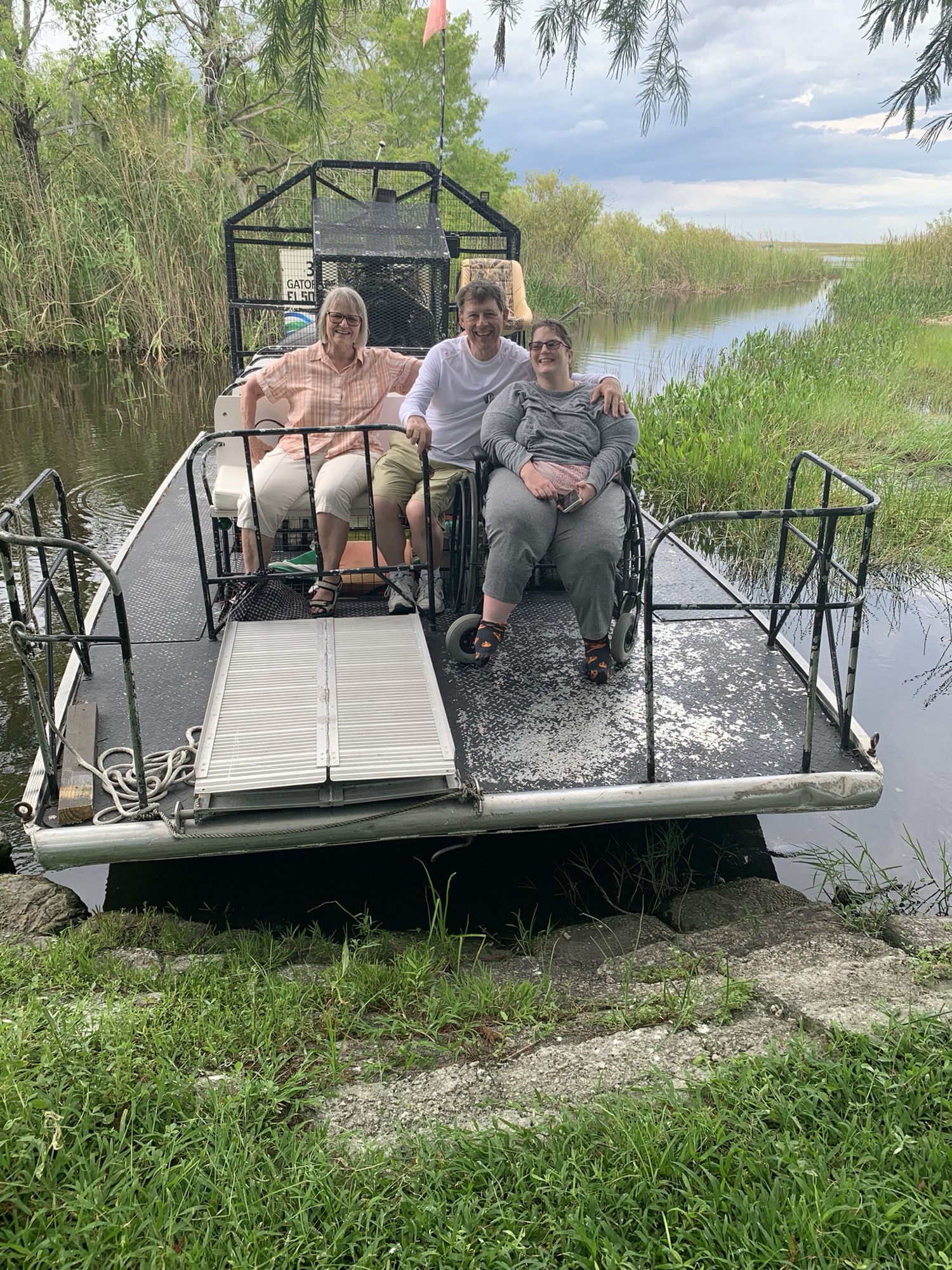 A wheelchair-using guest enjoying an accessible Everglades airboat tour