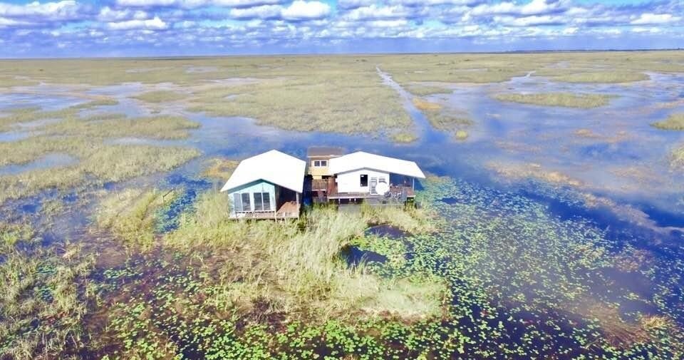Stilt camp house in open sawgrass seen on Everglades airboat tours in the northern Glades
