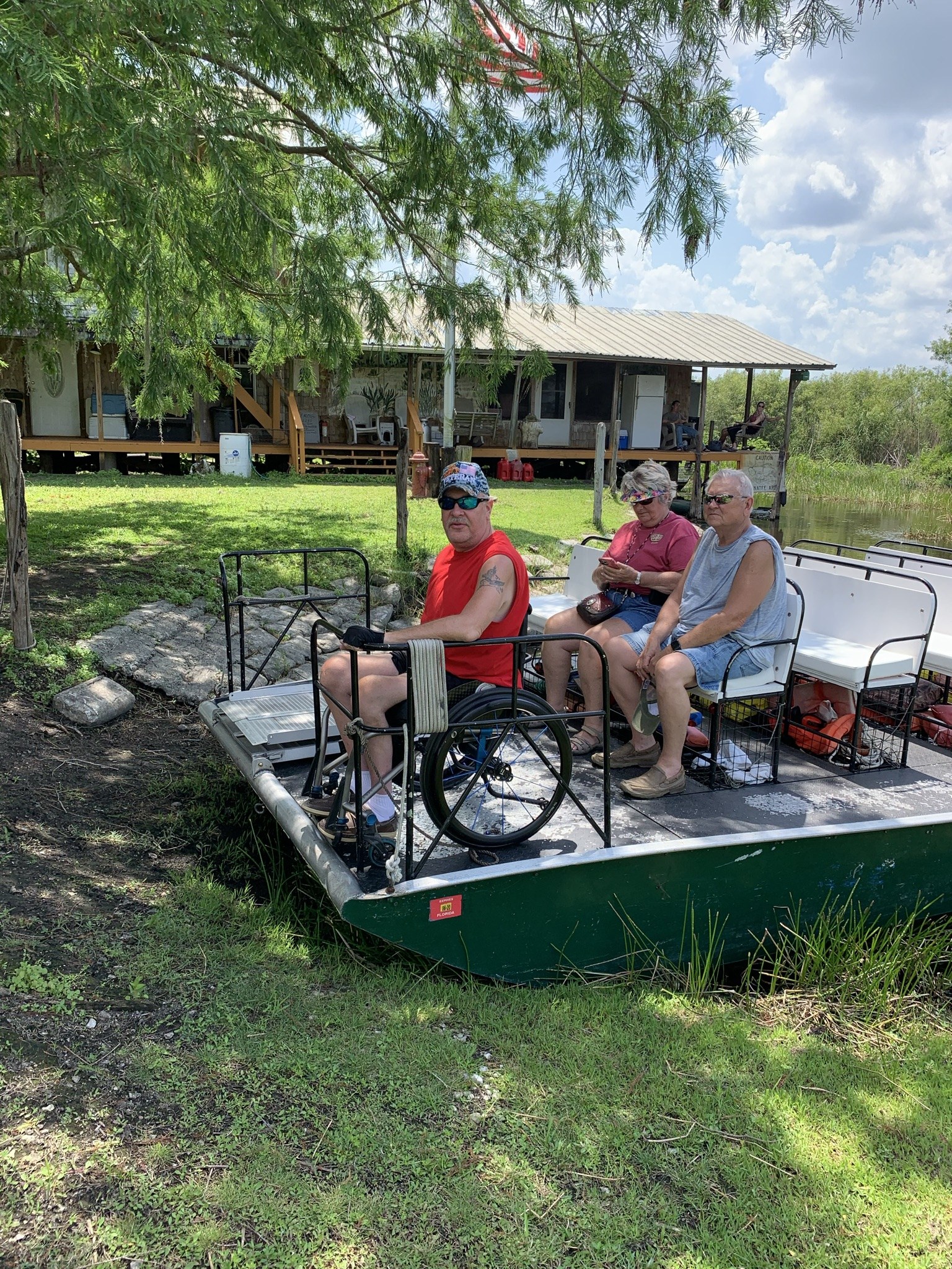 A wheelchair-using guest boarding an accessible Aces airboat on a ride near Tamarac