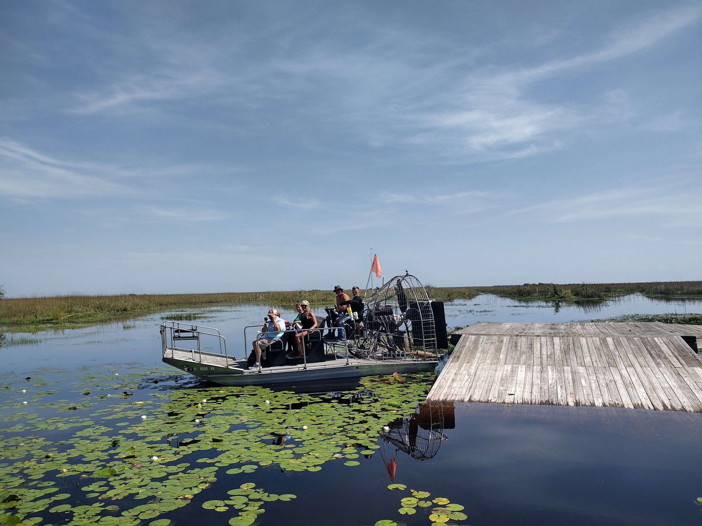 An Aces airboat beside the dock, ready for one of our private airboat tours South Florida guests book