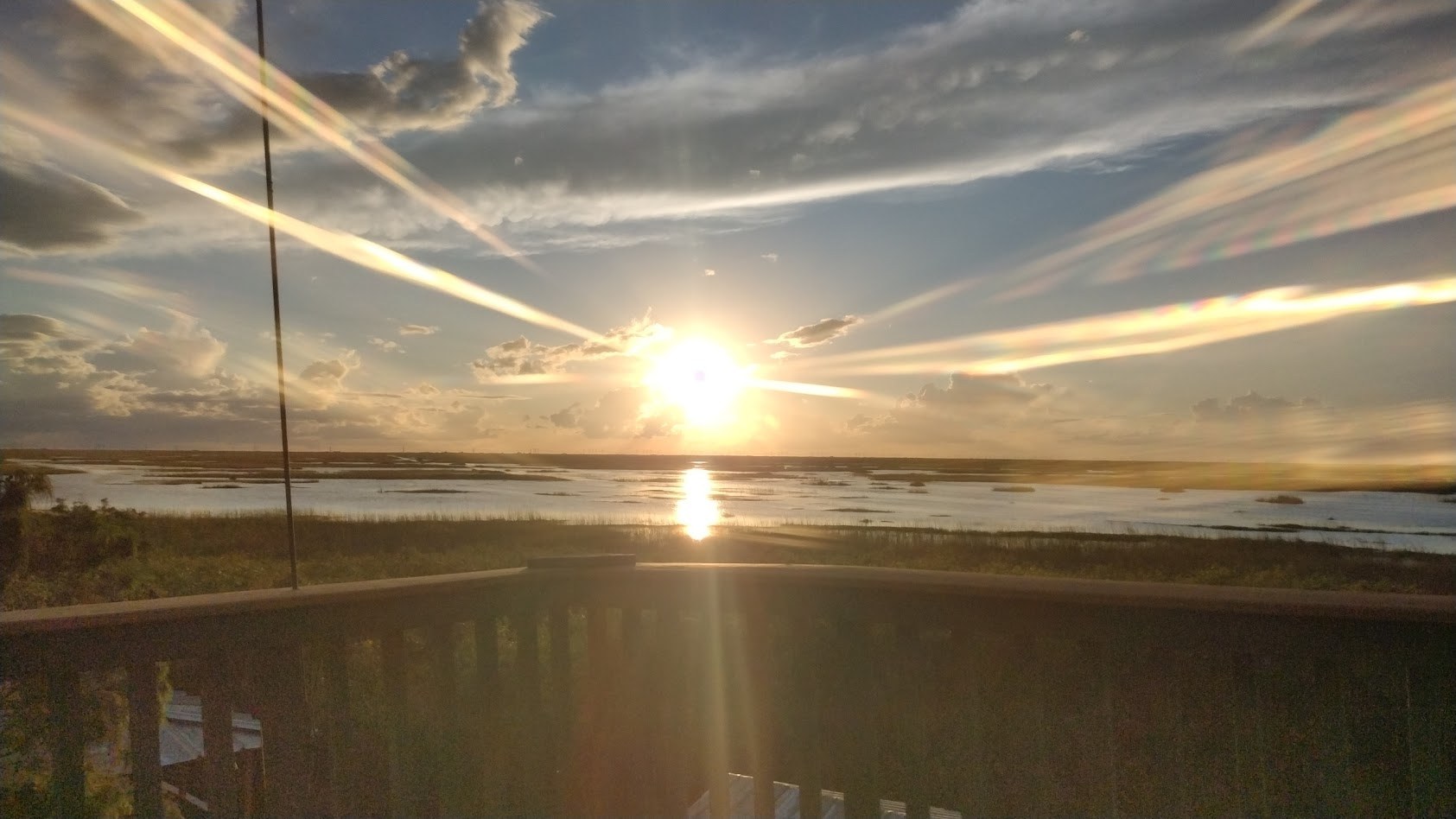 A brilliant sunset streaking the sky over the water on an evening airboat tour
